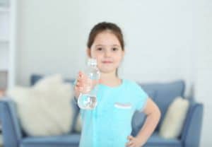 Little girl holding plastic bottle