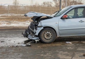 cracked-up front-end of a blue car