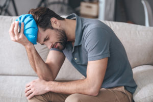 man nursing a head injury