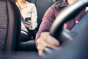 Phone,In,Car,Or,Taxi.,Passenger,Woman,Using,Cellphone,In
