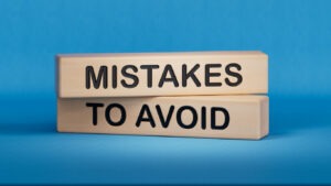 Two blocks of wood that say "Mistakes to Avoid"