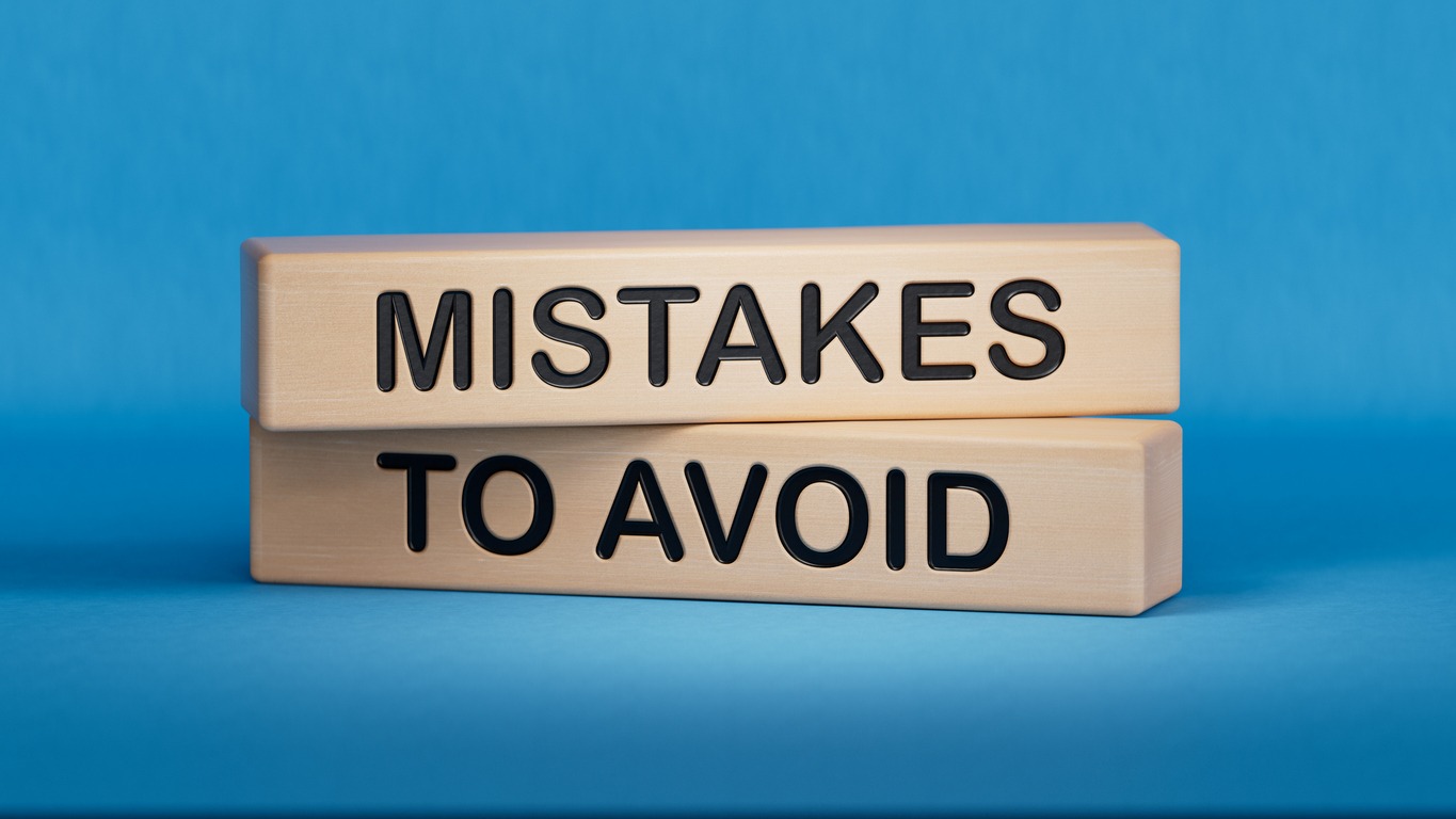 Two blocks of wood that say "Mistakes to Avoid"