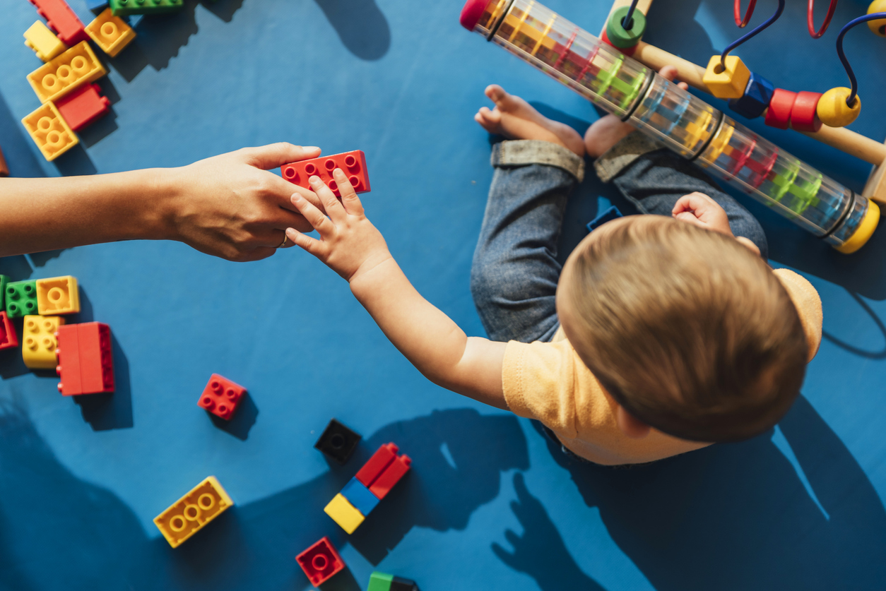 Child playing with toys on the ground